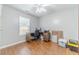 Functional bedroom with a computer desk, ceiling fan, and wood flooring at 130 White Sands Ct, Suwanee, GA 30024