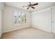 Neutral bedroom featuring plush carpeting, a ceiling fan, and plantation shutters for ample natural light at 130 White Sands Ct, Suwanee, GA 30024