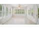 Sunlit breakfast room with windows, tiled floor, and views of the green backyard at 130 White Sands Ct, Suwanee, GA 30024