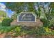 Stone sign at the community entrance, surrounded by lush landscaping, welcomes residents and guests at 130 White Sands Ct, Suwanee, GA 30024