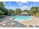 Large community pool with ample seating and a covered pavilion, perfect for summer relaxation at 130 White Sands Ct, Suwanee, GA 30024