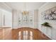 Elegant dining room with hardwood floors, bay window, chandelier, and neutral color palette at 130 White Sands Ct, Suwanee, GA 30024