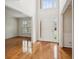 Bright foyer with hardwood floors and high ceilings leading into a formal living space at 130 White Sands Ct, Suwanee, GA 30024