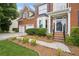 Inviting front entrance with a charming walkway, landscaped garden beds, and two car garage at 130 White Sands Ct, Suwanee, GA 30024