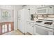 Well-lit kitchen showcasing a white refrigerator, oven, and view to breakfast area at 130 White Sands Ct, Suwanee, GA 30024