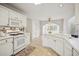 Bright kitchen with tiled floor, white countertops, cabinetry, view to breakfast room at 130 White Sands Ct, Suwanee, GA 30024