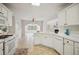 Bright kitchen with tiled floor, white countertops, appliances, and views of breakfast room and living room at 130 White Sands Ct, Suwanee, GA 30024