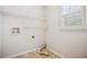 Clean laundry room features practical shelving and a bright window at 130 White Sands Ct, Suwanee, GA 30024