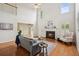 Cozy living room featuring a fireplace, hardwood floors, and lots of natural light at 130 White Sands Ct, Suwanee, GA 30024