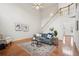 Bright living room with hardwood floors, a high ceiling, elegant decor, and staircase leading to the second floor at 130 White Sands Ct, Suwanee, GA 30024