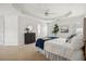 Spacious main bedroom features a tray ceiling, carpeted floor, and white walls at 130 White Sands Ct, Suwanee, GA 30024