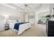 Large main bedroom offers a tray ceiling, carpet flooring, and ample natural light at 130 White Sands Ct, Suwanee, GA 30024