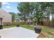 The backyard features a fenced yard, a patio with a grill, and an outdoor dining area at 133 Worthing Ln, Fairburn, GA 30213