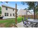 A fenced backyard featuring a patio area, a grassy lawn, and an outdoor dining space, perfect for relaxing at 133 Worthing Ln, Fairburn, GA 30213