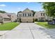 Charming two-story home with a well-manicured lawn and a spacious driveway leading to a two-car garage at 133 Worthing Ln, Fairburn, GA 30213
