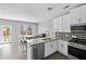 Well-lit kitchen featuring modern appliances and a dining area at 133 Worthing Ln, Fairburn, GA 30213