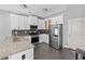 Modern kitchen with stainless steel appliances and granite countertops at 133 Worthing Ln, Fairburn, GA 30213