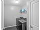 Clean laundry room featuring a washer, dryer, and storage shelves at 133 Worthing Ln, Fairburn, GA 30213