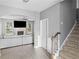 Bright living room featuring a fireplace, ceiling fan, and staircase at 133 Worthing Ln, Fairburn, GA 30213