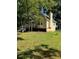 Serene backyard with a spacious deck, chimney, and surrounded by lush greenery at 4050 Willow Ridge Rd, Douglasville, GA 30135
