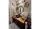 The bathroom is decorated with floral artwork and a gold mirror at 4050 Willow Ridge Rd, Douglasville, GA 30135