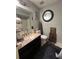Bathroom featuring a granite countertop, mirror, decor, and wood trim at 4050 Willow Ridge Rd, Douglasville, GA 30135