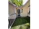 Charming front porch with a decorative door, lantern, cross, and artificial turf at 4050 Willow Ridge Rd, Douglasville, GA 30135