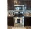 Kitchen featuring stainless steel oven, microwave and gas range at 4050 Willow Ridge Rd, Douglasville, GA 30135