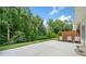 Open back patio featuring outdoor furniture and green space surrounded by lush trees at 490 Duval Dr, Alpharetta, GA 30009