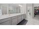 Spacious bathroom with double sinks, vanity, and a view into the walk-in closet, blending functionality and style at 490 Duval Dr, Alpharetta, GA 30009