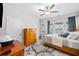 Comfortable bedroom with hardwood furniture, ceiling fan, and bright natural light at 490 Duval Dr, Alpharetta, GA 30009