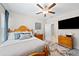 Cozy bedroom featuring a ceiling fan, television, rug, and comfortable bedding at 490 Duval Dr, Alpharetta, GA 30009