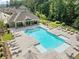 Aerial view of the community pool with lounge chairs and mature trees at 490 Duval Dr, Alpharetta, GA 30009