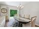 Dining room with chandelier, french doors that opens to nature view at 490 Duval Dr, Alpharetta, GA 30009