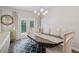 Dining room with modern chandelier, stylish rug, and french doors leading to the outside at 490 Duval Dr, Alpharetta, GA 30009