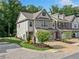Stunning two-story townhome with brick accents and a charming paver driveway and sidewalk at 490 Duval Dr, Alpharetta, GA 30009