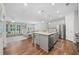 Open-concept kitchen with a large island, stainless steel appliances, and hardwood flooring at 490 Duval Dr, Alpharetta, GA 30009