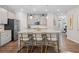 Open kitchen featuring an island with seating, stainless steel appliances, and granite countertops at 490 Duval Dr, Alpharetta, GA 30009