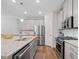 Bright kitchen with stainless steel appliances, a center island, and hardwood floors at 490 Duval Dr, Alpharetta, GA 30009