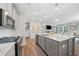 Stylish kitchen with a large island, stainless steel appliances, and a view into the living room at 490 Duval Dr, Alpharetta, GA 30009