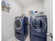 Contemporary laundry room with a front load washer and dryer on pedestals at 490 Duval Dr, Alpharetta, GA 30009