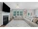 Spacious living room with fireplace, large TV, and a comfortable sectional sofa at 490 Duval Dr, Alpharetta, GA 30009