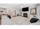 Inviting living room features a fireplace, a large television, and an oversized couch, perfect for relaxing and entertaining at 490 Duval Dr, Alpharetta, GA 30009