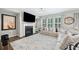 Bright living room with fireplace, large TV, and a large cozy sectional at 490 Duval Dr, Alpharetta, GA 30009