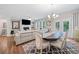 Open layout shows dining area with doors, connected to living room with fireplace at 490 Duval Dr, Alpharetta, GA 30009