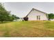 The backyard features a large grassy area with shrubbery at 12384 Riviera Dr, Fayetteville, GA 30215
