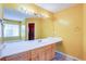 This bathroom features yellow walls and granite countertops at 12384 Riviera Dr, Fayetteville, GA 30215