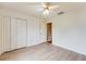 Bright bedroom features neutral walls, ceiling fan, closet and newly installed flooring at 12384 Riviera Dr, Fayetteville, GA 30215