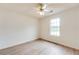 Bedroom with wood-look floors, a ceiling fan, and natural light from a large window at 12384 Riviera Dr, Fayetteville, GA 30215