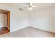 Well-lit bedroom with neutral walls, wood-look flooring, and a ceiling fan at 12384 Riviera Dr, Fayetteville, GA 30215